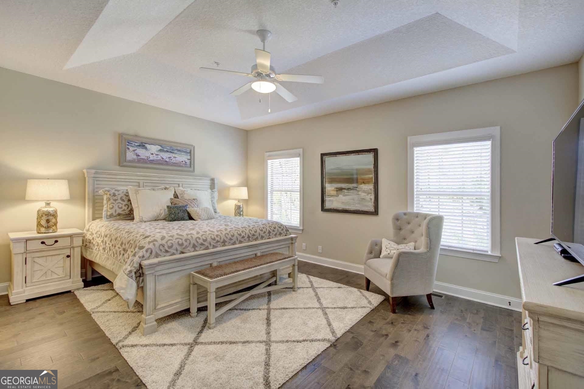 205 Mariners Circle St. Simons, GA 31522 - Photo 24 of 51 a bedroom with a bed and a chandelier