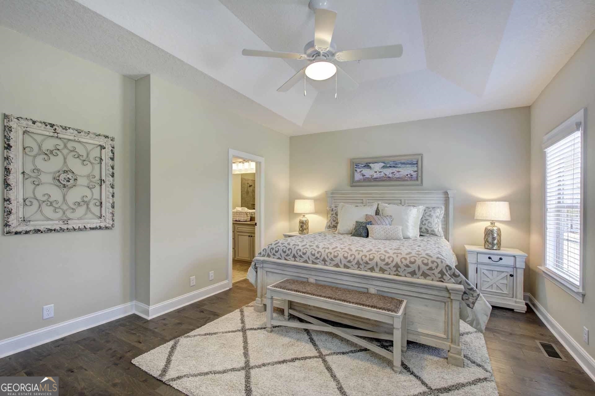 205 Mariners Circle St. Simons, GA 31522 - Photo 25 of 51 a bedroom with a bed and a chandelier