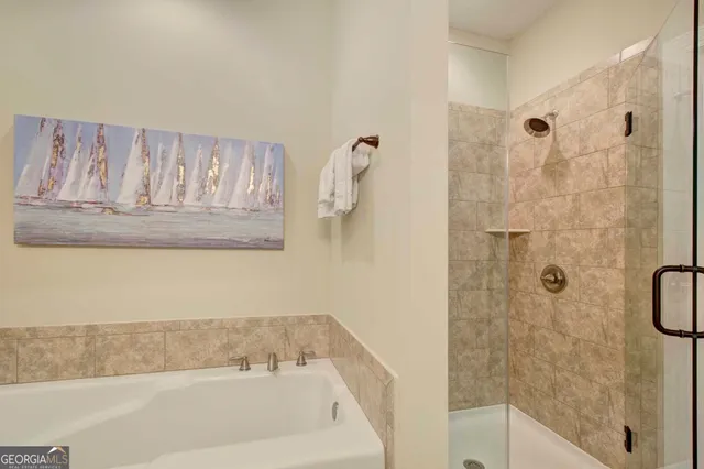 a bathroom with a bathtub and shower