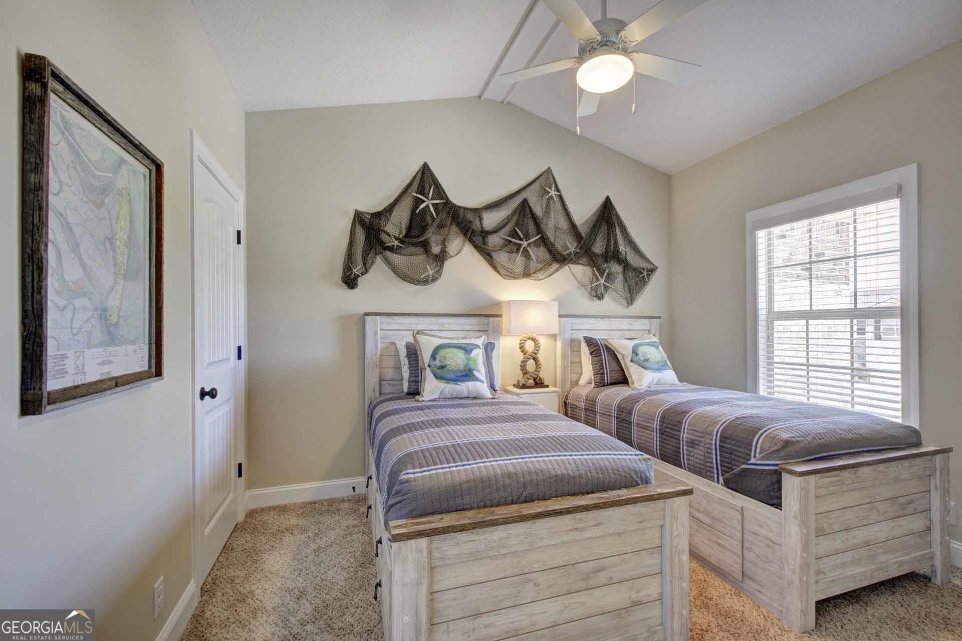 205 Mariners Circle St. Simons, GA 31522 - Photo 34 of 51 a bedroom with a bed and a chandelier