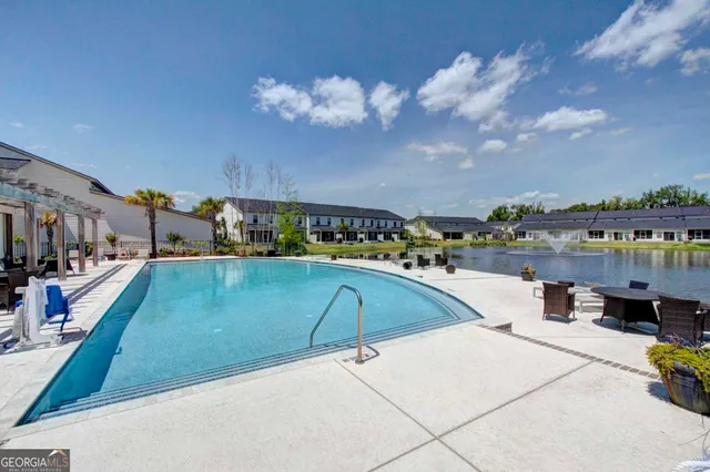 a view of swimming pool with outdoor seating and city view
