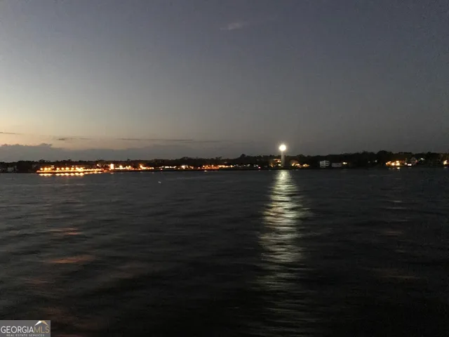 a view of a dry yard with wooden fence