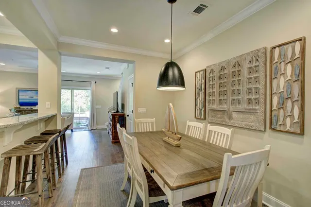 a dining room with furniture and wooden floor