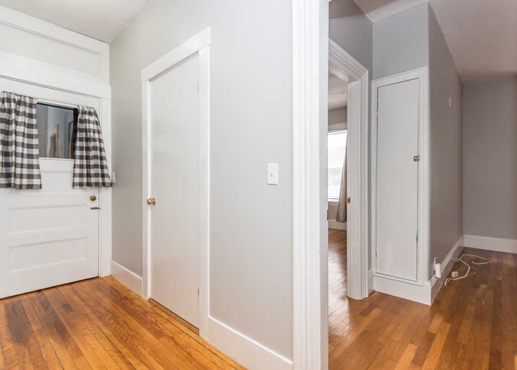 21 Gardner Street, Unit 1 Waltham, MA 02453 - Photo 11 of 19 a view of hallway with wooden floor