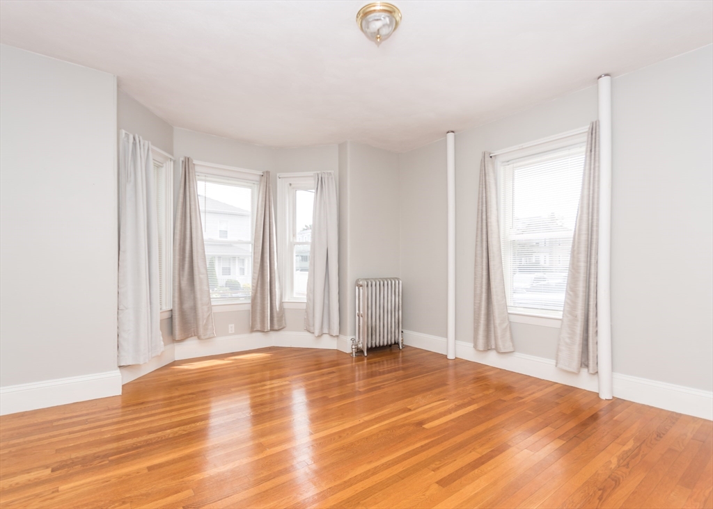 21 Gardner Street, Unit 1 Waltham, MA 02453 - Photo 12 of 19 a view of empty room with wooden floor and fan