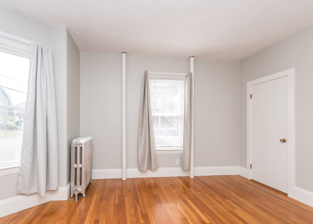 21 Gardner Street, Unit 1 Waltham, MA 02453 - Photo 13 of 19 a bedroom with a bed and a window
