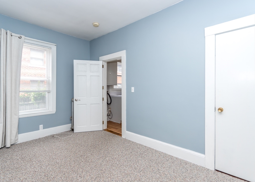 21 Gardner Street, Unit 1 Waltham, MA 02453 - Photo 16 of 19 a view of an empty room with a window