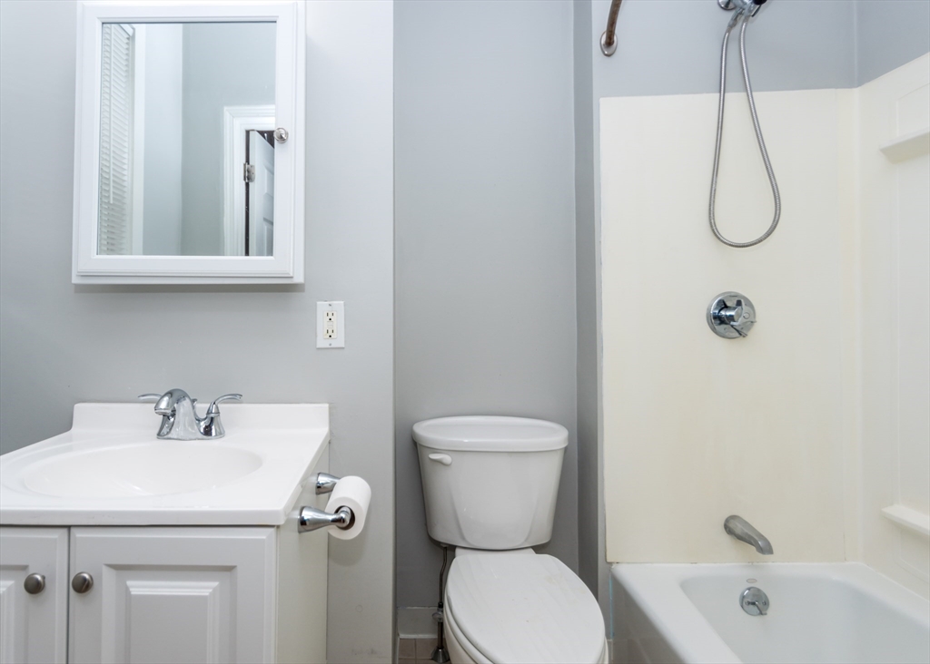 21 Gardner Street, Unit 1 Waltham, MA 02453 - Photo 18 of 19 a bathroom with a sink a toilet and shower