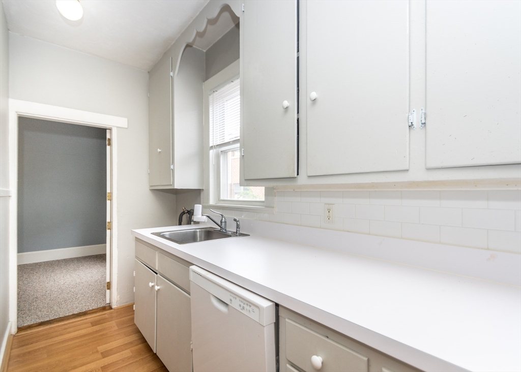 21 Gardner Street, Unit 1 Waltham, MA 02453 - Photo 6 of 19 a bathroom with a sink and a mirror