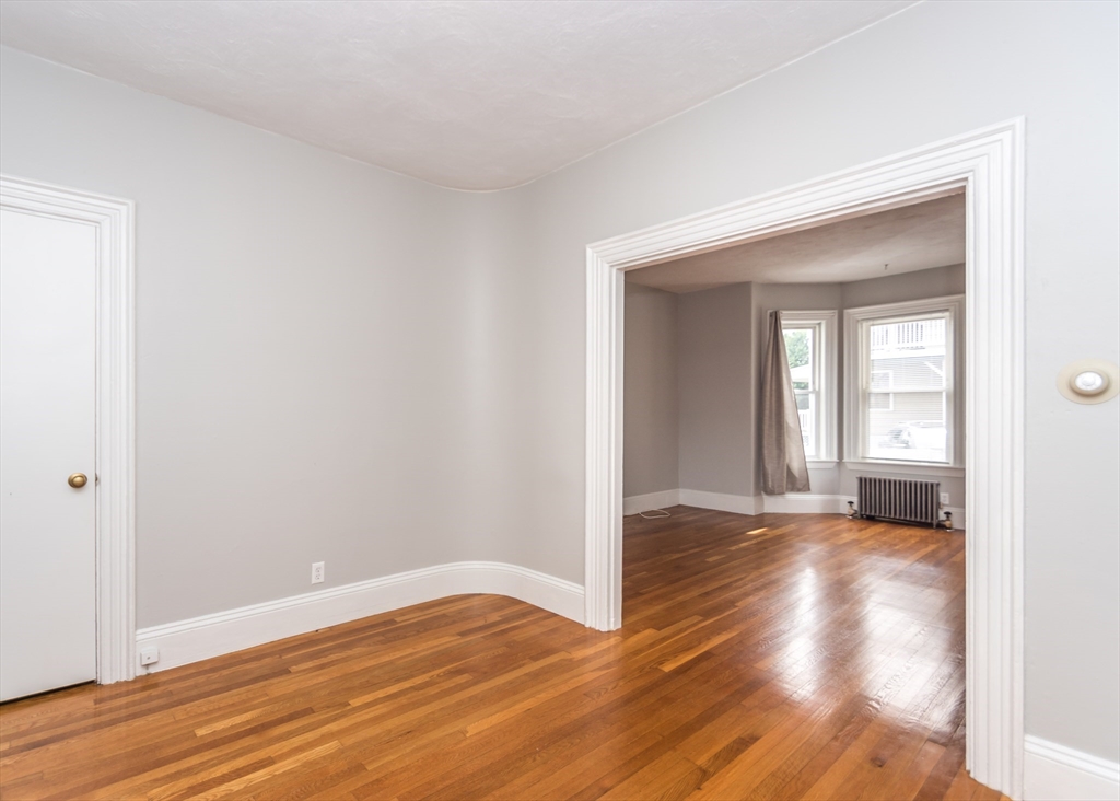 21 Gardner Street, Unit 1 Waltham, MA 02453 - Photo 7 of 19 a view of a livingroom with wooden floor