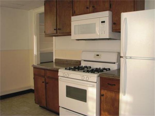 28 Washington Square Gloucester, MA 01930 - Photo 19 of 26 a kitchen with a stove and a microwave