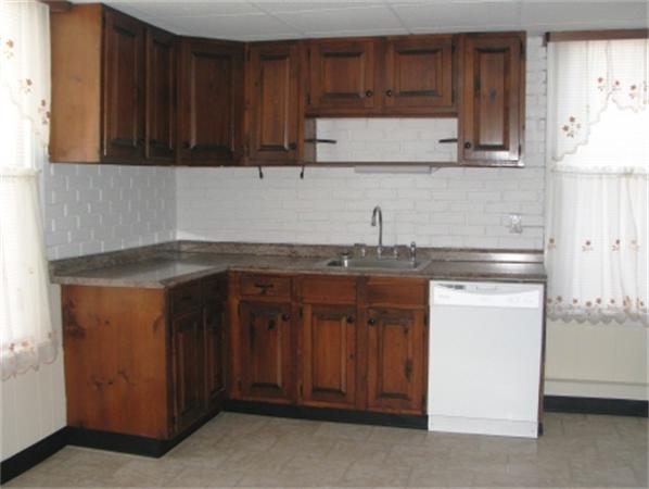 28 Washington Square Gloucester, MA 01930 - Photo 22 of 26 a kitchen with stainless steel appliances granite countertop a refrigerator and a stove top oven