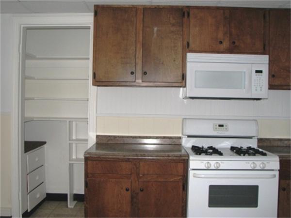 28 Washington Square Gloucester, MA 01930 - Photo 23 of 26 a stove top oven sitting inside of a kitchen