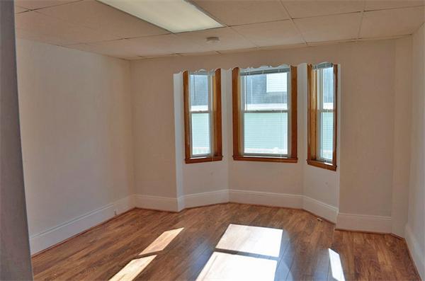 28 Washington Square Gloucester, MA 01930 - Photo 7 of 26 a view of an empty room with wooden floor and a window