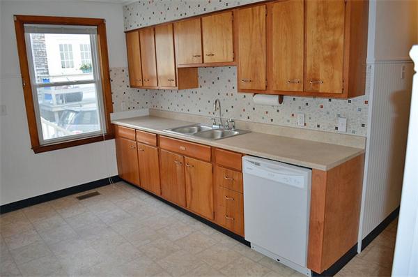 28 Washington Square Gloucester, MA 01930 - Photo 9 of 26 a kitchen with stainless steel appliances granite countertop a sink stove and cabinets