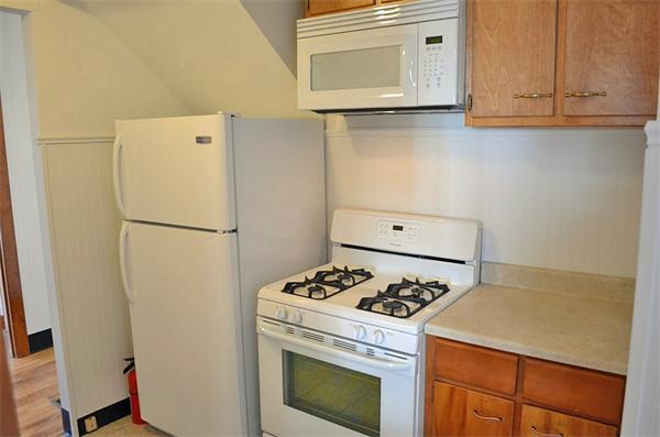 28 Washington Square Gloucester, MA 01930 - Photo 10 of 26 a kitchen with a stove and a refrigerator