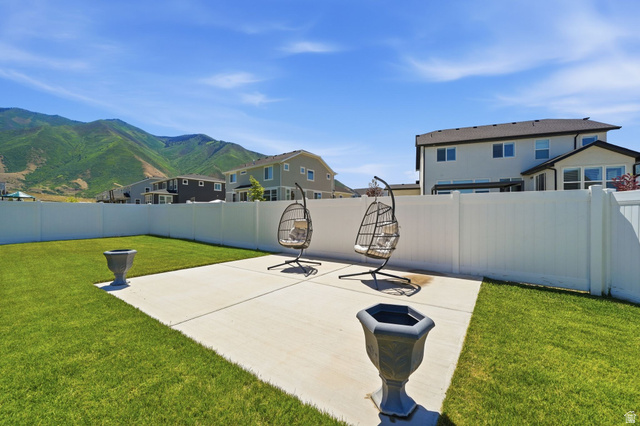 1165 West Union Bench Drive Mapleton, UT 84664 - Photo 55 of 61 Expansive backyard featuring a lush lawn and a concrete patio