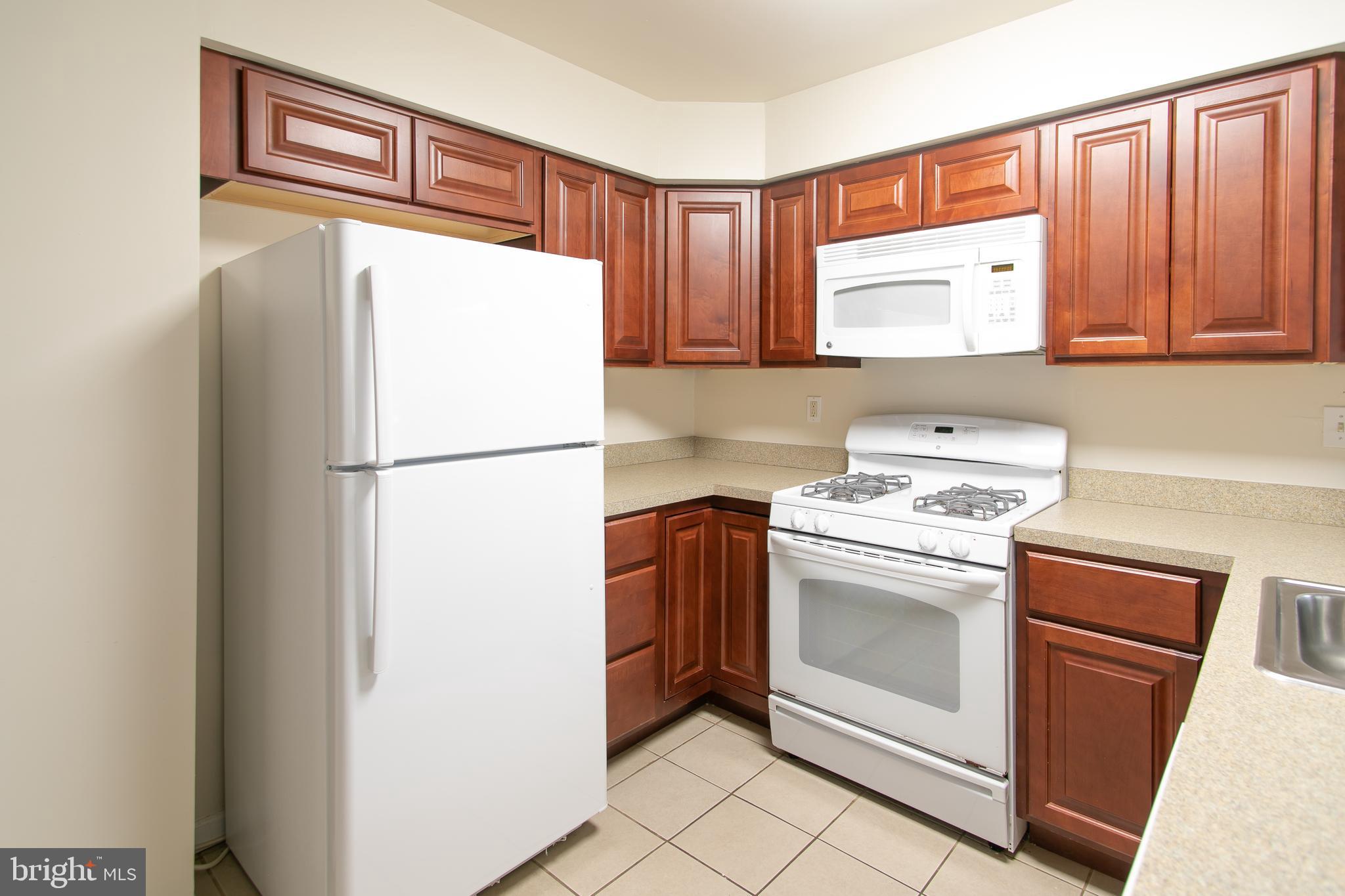 613 New York Road Glassboro, NJ 08028 - Photo 6 of 27 a kitchen with stainless steel appliances granite countertop a refrigerator sink and cabinets