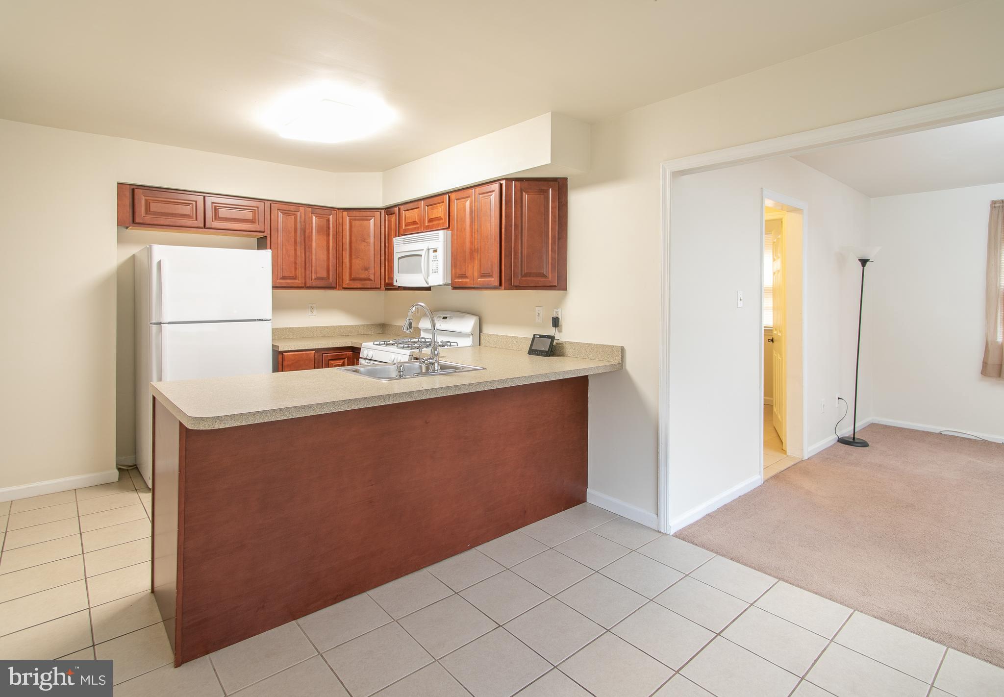 613 New York Road Glassboro, NJ 08028 - Photo 8 of 27 a kitchen with a refrigerator sink and cabinets
