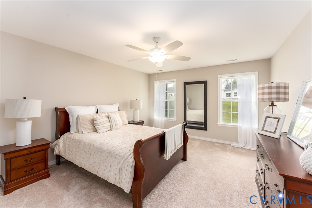 136 Wendenburg Court, Unit G2 Aylett, VA 23009 - Photo 11 of 31 a bedroom with a large bed and a chandelier
