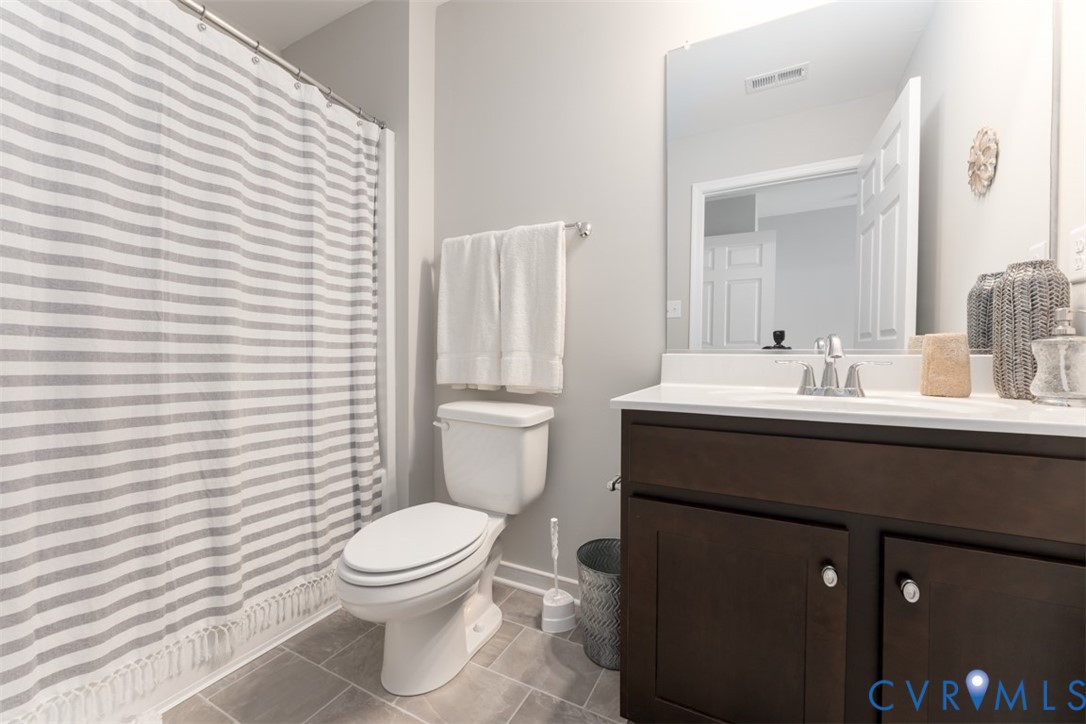 136 Wendenburg Court, Unit G2 Aylett, VA 23009 - Photo 3 of 31 a bathroom with a sink a toilet and shower curtain