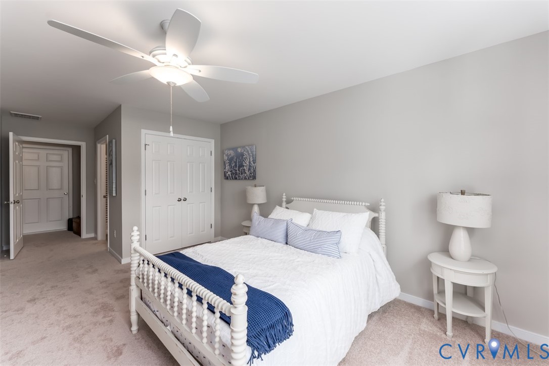 136 Wendenburg Court, Unit G2 Aylett, VA 23009 - Photo 5 of 31 a bedroom with a bed and a chandelier