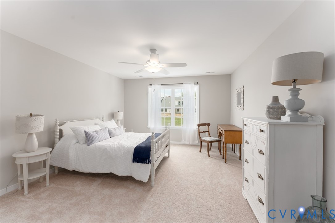 136 Wendenburg Court, Unit G2 Aylett, VA 23009 - Photo 6 of 31 a spacious bedroom with a bed and a chandelier