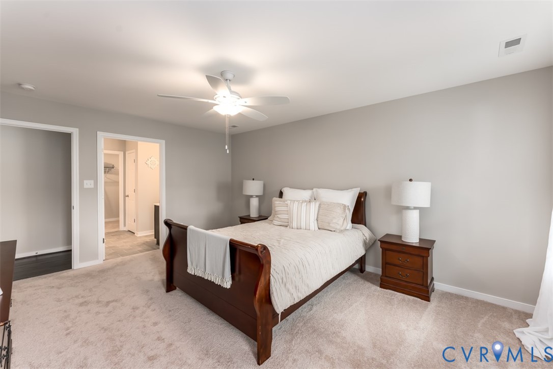 136 Wendenburg Court, Unit G2 Aylett, VA 23009 - Photo 10 of 31 a bedroom with a bed and a chandelier