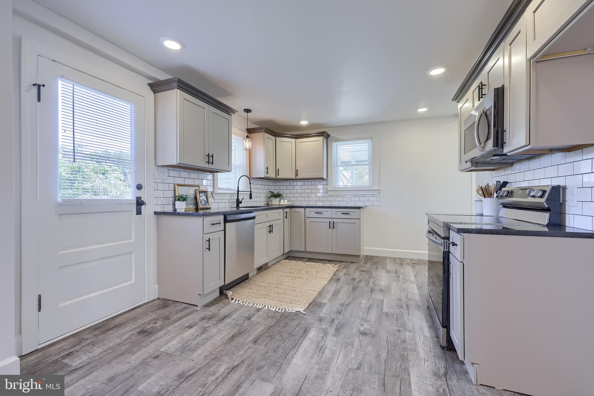 1151 Delta Road Red Lion, PA 17356 - Photo 13 of 44 a kitchen with stainless steel appliances granite countertop wooden cabinets a sink a stove a refrigerator and cabinets