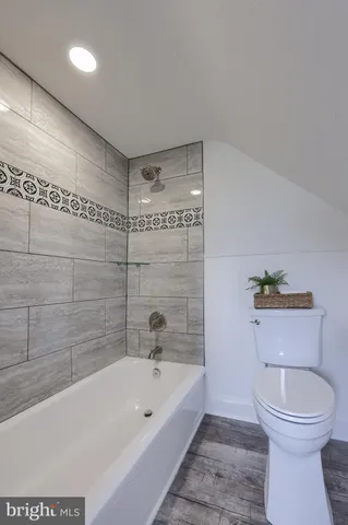 a bathroom with a toilet a sink and bathtub