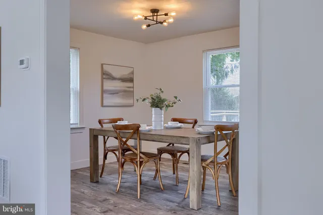 a view of a dining room with furniture and chandelier