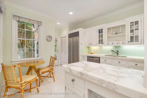 a kitchen with stainless steel appliances kitchen island granite countertop a sink and cabinets