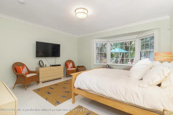 a bedroom with a bed and glass window