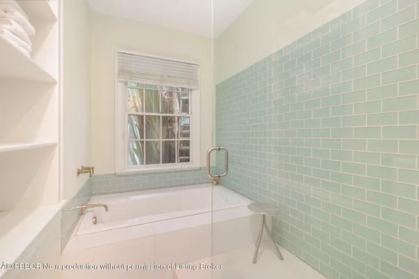 a bathroom with a bathtub and window