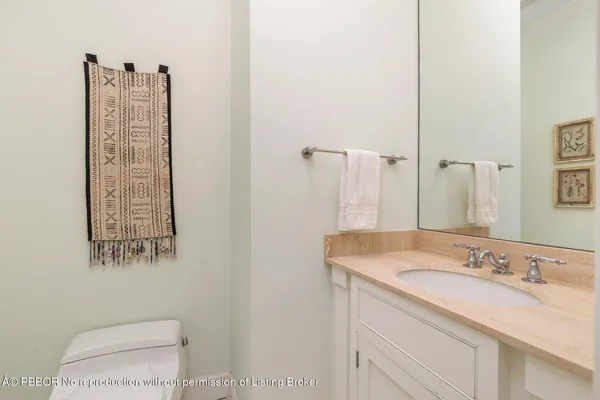 a bathroom with a sink vanity and a toilet