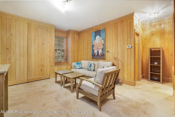 a living room with furniture a dining table and a window