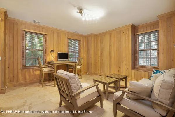 a living room with furniture a flat screen tv and a window