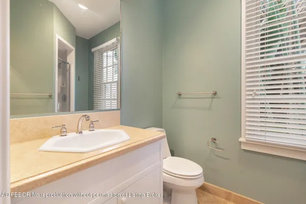 a bathroom with a sink toilet and window