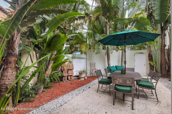 a view of backyard of house with seating space