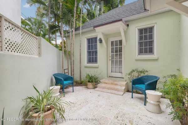 a house with a potted plant and outdoor seating