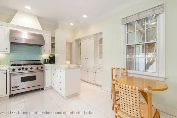 a kitchen with a stove a sink and a cabinets