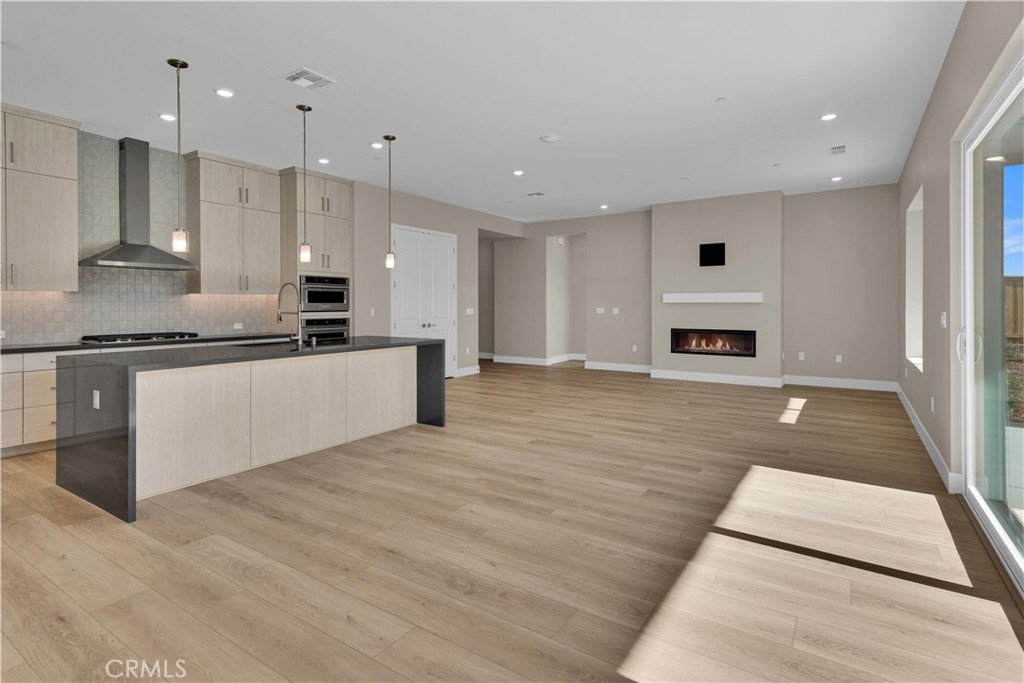 1330 Cava Road Paso Robles, CA 93446 - Photo 4 of 14 a large kitchen with stainless steel appliances kitchen island granite countertop a stove a sink and a microwave