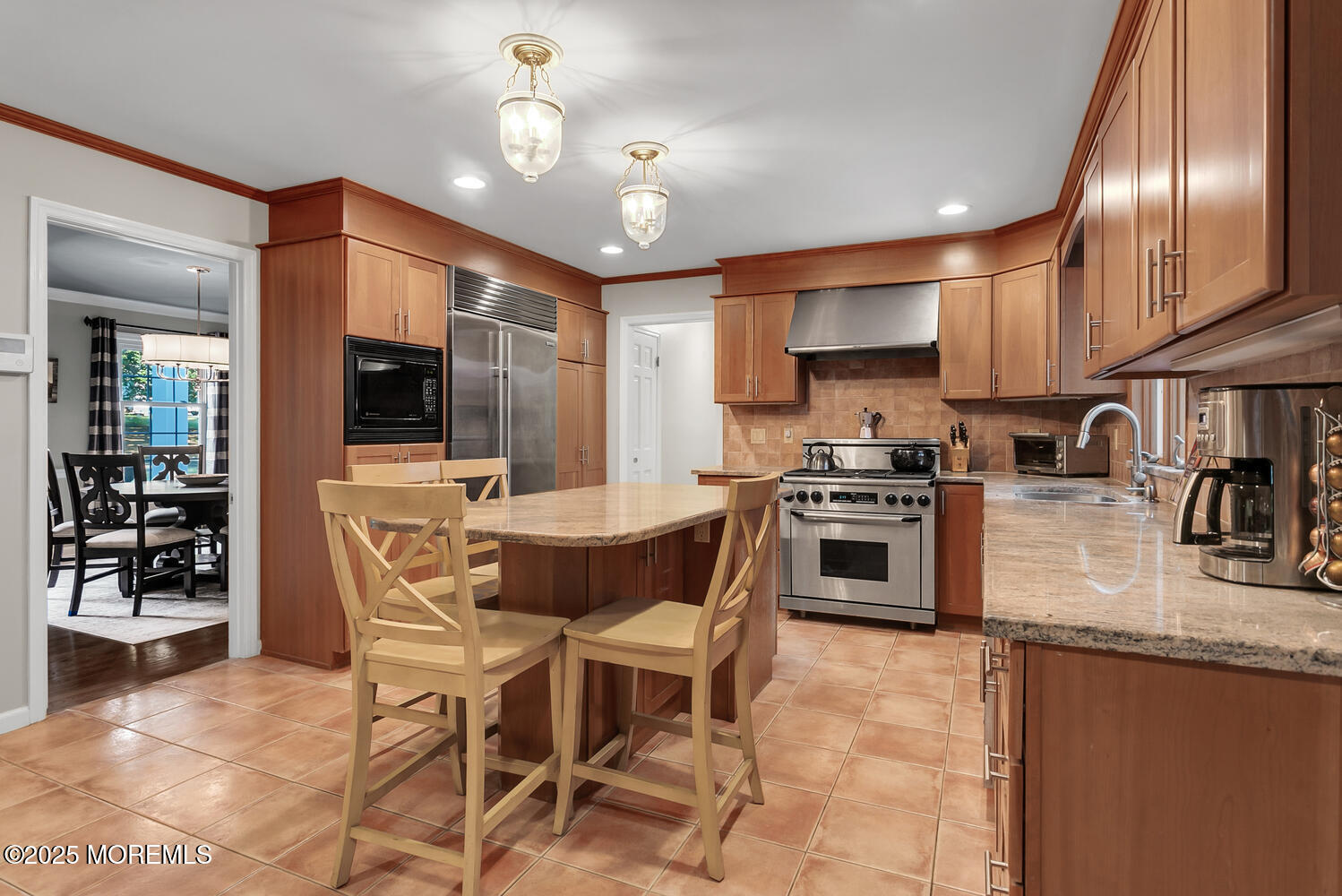 5 Page Drive Red Bank, NJ 07701 - Photo 9 of 27 a kitchen with stainless steel appliances granite countertop a stove top oven a sink dishwasher a dining table and chairs with wooden floor