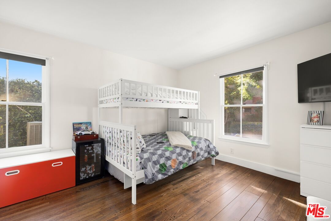 1456 Roscomare Road Los Angeles, CA 90077 - Photo 15 of 21 a bedroom with a bed and wooden floor