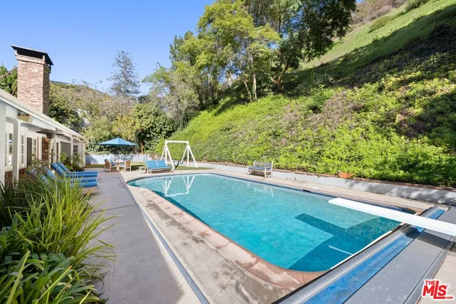 a view of a swimming pool with a patio