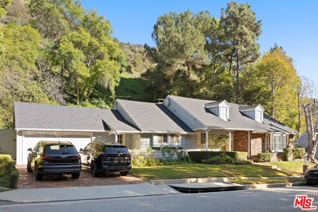 1456 Roscomare Road Los Angeles, CA 90077 - Photo 2 of 21 a car parked in front of a house