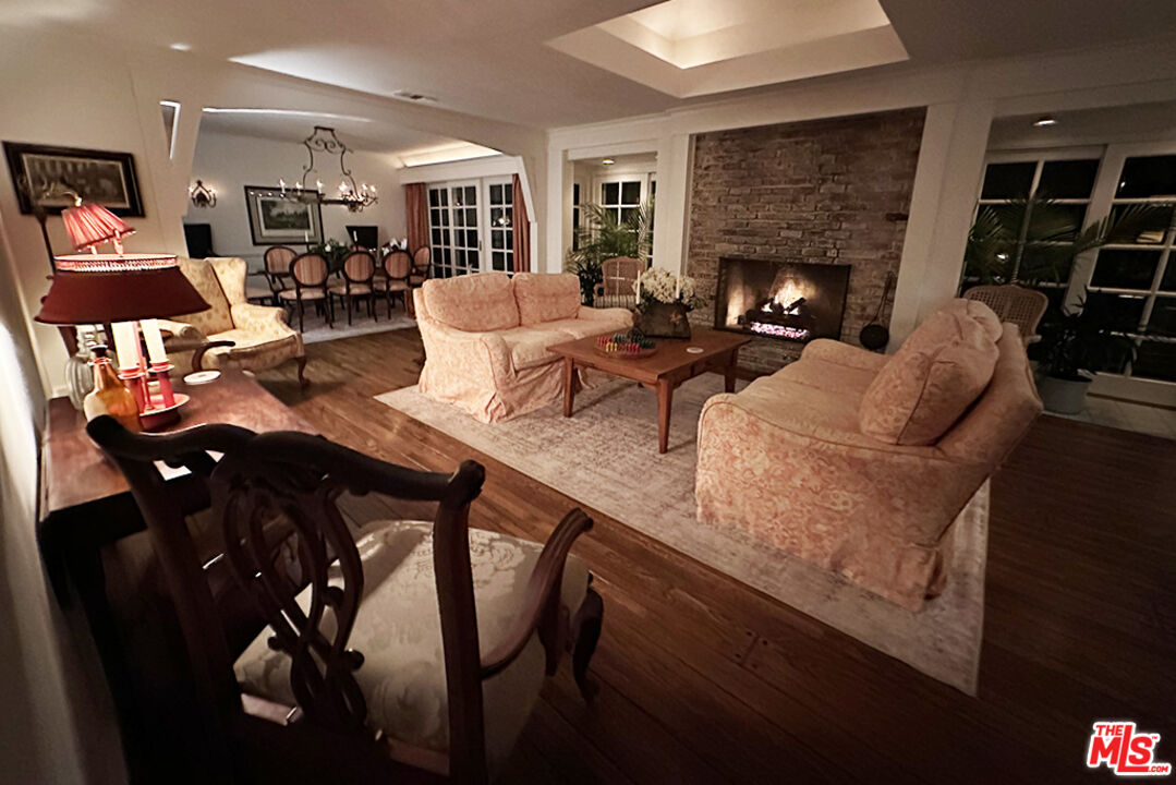 1456 Roscomare Road Los Angeles, CA 90077 - Photo 4 of 21 a living room with furniture kitchen view and a fireplace