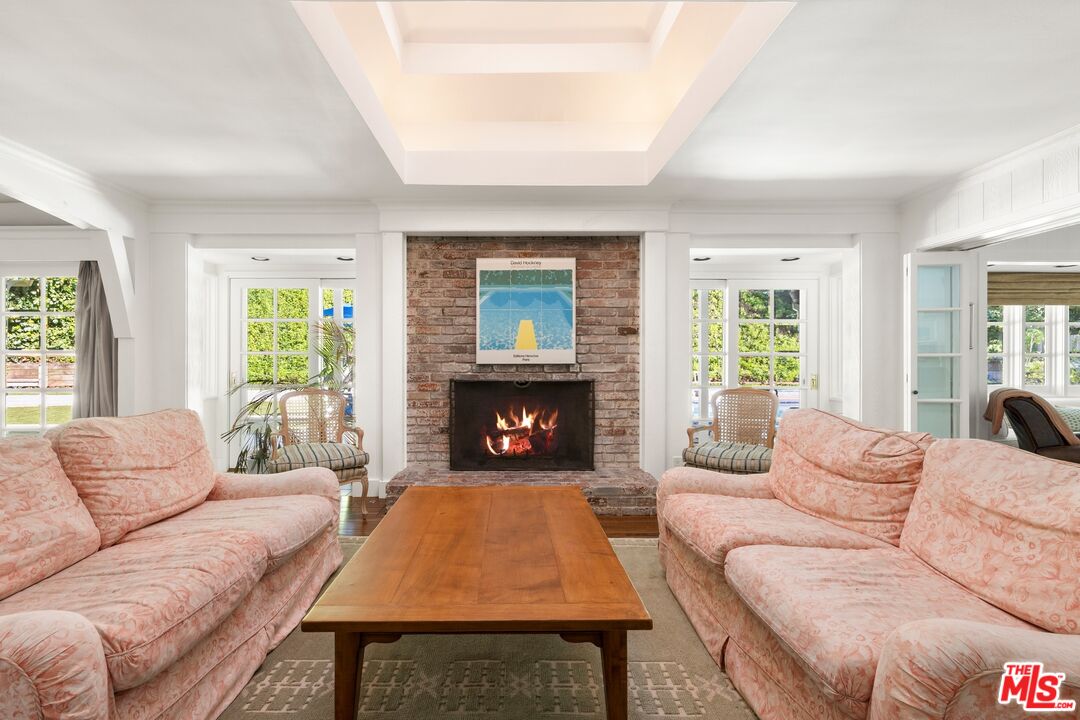 1456 Roscomare Road Los Angeles, CA 90077 - Photo 5 of 21 a living room with furniture a window and a fireplace