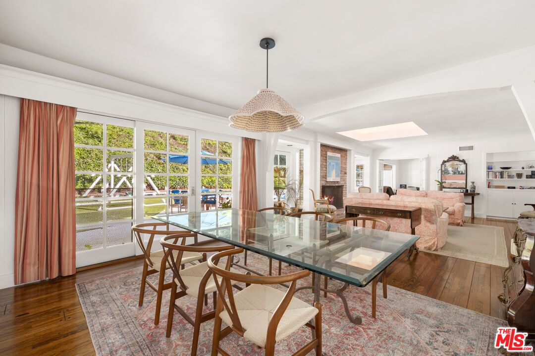 1456 Roscomare Road Los Angeles, CA 90077 - Photo 6 of 21 a dining room with furniture a chandelier and wooden floor