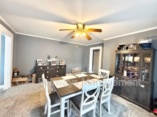 a dining room with furniture and window